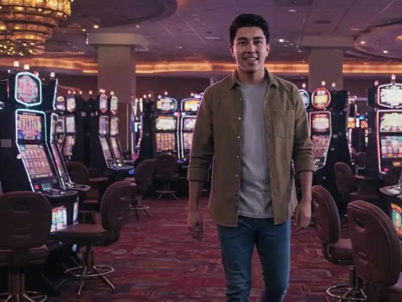 Man walking through slot machines at Maharlika Play casino